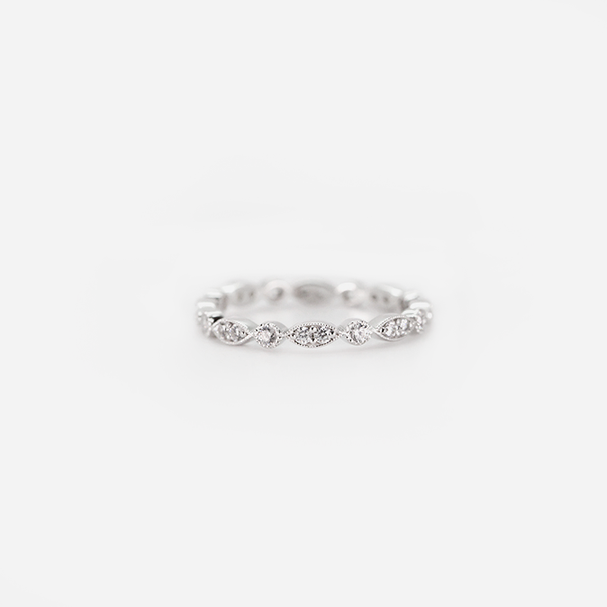 18ct white gold milgrain edge band set with brilliant cut diamonds giving a marquise illusion effect